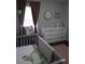 Comfortable Bedroom featuring a crib, changing table, soft lighting, and stylish decorations at 1006 Harvest Moon Dr, Seffner, FL 33584