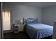 This bedroom has stylish hardwood floors and access to the outside at 1006 Harvest Moon Dr, Seffner, FL 33584