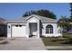 Charming single-story home featuring a well-maintained front yard, gray paint, and attached one-car garage at 1006 Harvest Moon Dr, Seffner, FL 33584