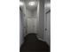 Neutral hallway features wood-look floors and white doors at 1006 Harvest Moon Dr, Seffner, FL 33584