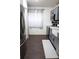 Galley kitchen featuring gray cabinets, stainless steel appliances, dark wood floors and a white farmhouse sink at 1006 Harvest Moon Dr, Seffner, FL 33584