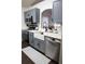 Updated kitchen with gray cabinets, stainless steel appliances, and a farmhouse sink under an arched pass-through window at 1006 Harvest Moon Dr, Seffner, FL 33584