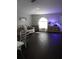 Spacious living area with hardwood floors, white sofa, arched window, and an aquarium providing ambient lighting at 1006 Harvest Moon Dr, Seffner, FL 33584