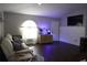 Inviting living room features dark floors, a fish tank and large, arched window at 1006 Harvest Moon Dr, Seffner, FL 33584