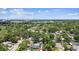 Expansive aerial view of a suburban community with lush greenery and clear skies at 10215 N 23Rd St, Tampa, FL 33612