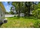 Spacious backyard featuring lush greenery and a convenient storage shed, ideal for outdoor activities at 10215 N 23Rd St, Tampa, FL 33612