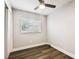 Cozy bedroom with ceiling fan, neutral walls, and new flooring at 10215 N 23Rd St, Tampa, FL 33612