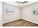 Bedroom featuring a ceiling fan, neutral walls, and new flooring at 10215 N 23Rd St, Tampa, FL 33612