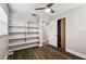 Bright bedroom features built-in shelving, a ceiling fan and light hardwood floors at 10215 N 23Rd St, Tampa, FL 33612