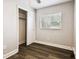 Bedroom with large closet, neutral walls, ceiling fan, and new flooring at 10215 N 23Rd St, Tampa, FL 33612