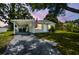 Charming single-story home with gray exterior, covered parking, and an American flag at 10215 N 23Rd St, Tampa, FL 33612