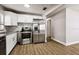 Well-lit kitchen with modern stainless steel appliances and white cabinetry at 10215 N 23Rd St, Tampa, FL 33612