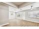 Bright living room featuring updated flooring, new windows, and a stylish front door at 10215 N 23Rd St, Tampa, FL 33612