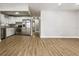 Open-concept living space featuring a modern kitchen and laminate wood flooring at 10215 N 23Rd St, Tampa, FL 33612