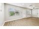 Bright living room with new laminate floors, a front door with glass and neutral colors at 10215 N 23Rd St, Tampa, FL 33612