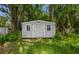 Exterior view of the backyard shed surrounded by trees at 10215 N 23Rd St, Tampa, FL 33612