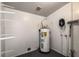 Utility room shows the water heater with attached shelving at 10215 N 23Rd St, Tampa, FL 33612