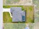 Aerial view of a property with a pool and gray roof at 10237 Deerwood Ave, Englewood, FL 34224