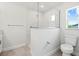 Modern bathroom featuring a walk-in shower with sleek glass partition and toilet with plenty of room at 10237 Deerwood Ave, Englewood, FL 34224
