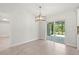 Open dining area featuring sliding glass doors leading to a screened lanai, offering seamless indoor-outdoor living at 10237 Deerwood Ave, Englewood, FL 34224