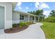 Inviting front porch and pathway with landscaping that leads to the main entrance of the home at 10237 Deerwood Ave, Englewood, FL 34224