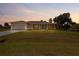 Charming single-story home with a well-maintained lawn and attached garage at 10237 Deerwood Ave, Englewood, FL 34224