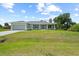 Charming single-story home with a well-maintained lawn and attached garage at 10237 Deerwood Ave, Englewood, FL 34224