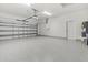 Spacious garage with epoxy floors, ample lighting, and garage door opener at 10237 Deerwood Ave, Englewood, FL 34224