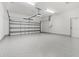 Spacious garage with epoxy floors, ample lighting, and garage door opener at 10237 Deerwood Ave, Englewood, FL 34224