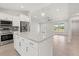 Spacious kitchen with island, stainless appliances, and open to a bright living area at 10237 Deerwood Ave, Englewood, FL 34224