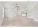 Open-concept living area with tile flooring, modern lighting, and a view into the kitchen at 10237 Deerwood Ave, Englewood, FL 34224