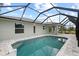 Backyard pool area with screened-in porch at 10237 Deerwood Ave, Englewood, FL 34224