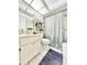 Bathroom with a shower/tub combo, vanity and white commode at 10636 Millriver Dr, New Port Richey, FL 34654