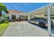 Charming single-story home with a covered carport and meticulously landscaped front yard at 10636 Millriver Dr, New Port Richey, FL 34654
