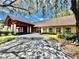 Wide exterior shot of the building with a covered entrance and lush landscaping at 10636 Millriver Dr, New Port Richey, FL 34654