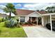 Inviting single-story home with a well-manicured lawn, mature landscaping, and convenient carport at 10636 Millriver Dr, New Port Richey, FL 34654