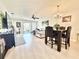 Bright living room with light wood floors, a ceiling fan, and access to an outdoor space at 10636 Millriver Dr, New Port Richey, FL 34654
