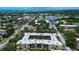 An aerial view of the condo community, with views of the surrounding neighborhood, trees, and water features at 11485 Oakhurst Rd # 310, Largo, FL 33771