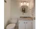 Bright bathroom featuring a marble-top vanity and a toilet at 11485 Oakhurst Rd # 310, Largo, FL 33771