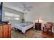 Bedroom features a ceiling fan, window, and decorative rug at 11485 Oakhurst Rd # 310, Largo, FL 33771