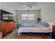 Cozy bedroom with a bed, dresser, vintage decor and a large window with natural light at 11485 Oakhurst Rd # 310, Largo, FL 33771
