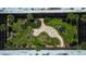 Aerial view of a beautifully landscaped courtyard with meandering walkways and inviting outdoor seating areas at 11485 Oakhurst Rd # 310, Largo, FL 33771