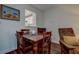 Dining room area with dark wood table and view into the kitchen at 11485 Oakhurst Rd # 310, Largo, FL 33771