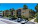 Beautiful condo building with palm trees and well-maintained landscaping under a sunny sky at 11485 Oakhurst Rd # 310, Largo, FL 33771