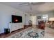 Living room with wood floors, area rug, TV, dining area, and comfortable seating arrangements at 11485 Oakhurst Rd # 310, Largo, FL 33771