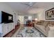 Bright living area with a cozy sofa, modern entertainment center, and an open layout at 11485 Oakhurst Rd # 310, Largo, FL 33771
