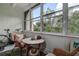 Enclosed lanai with plants and table at 11485 Oakhurst Rd # 310, Largo, FL 33771