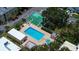 Aerial view of a community pool, shuffleboard courts and mature trees at 11485 Oakhurst Rd # 310, Largo, FL 33771