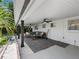 Spacious covered back porch with outdoor seating, ceiling fans, and views of the lush backyard at 1154 64Th S Ave, St Petersburg, FL 33705