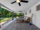Inviting covered back porch featuring a ceiling fan and comfortable seating, perfect for outdoor relaxation and entertaining at 1154 64Th S Ave, St Petersburg, FL 33705